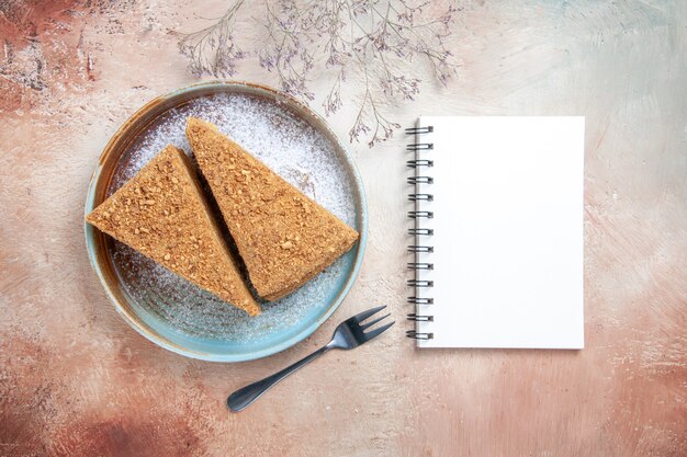 delicious honey cake inside tray on gray