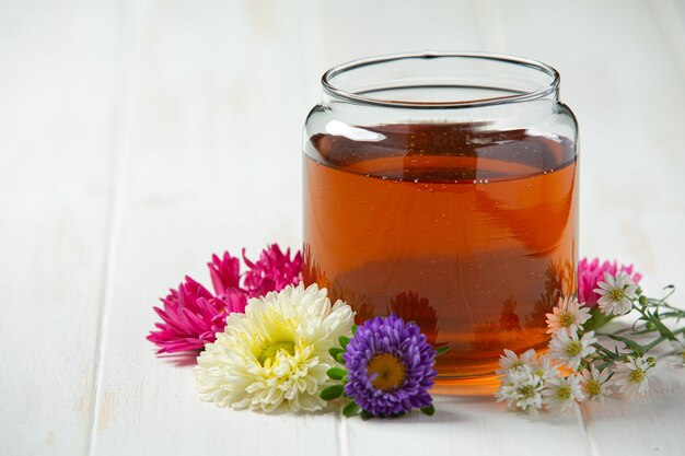 Delicious honey on white wooden surface