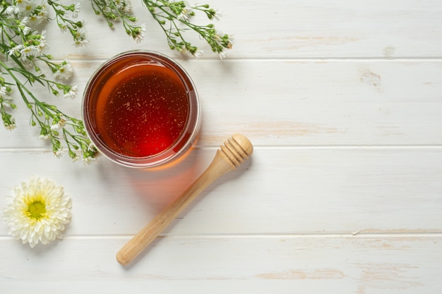 Delicious honey on white wooden surface