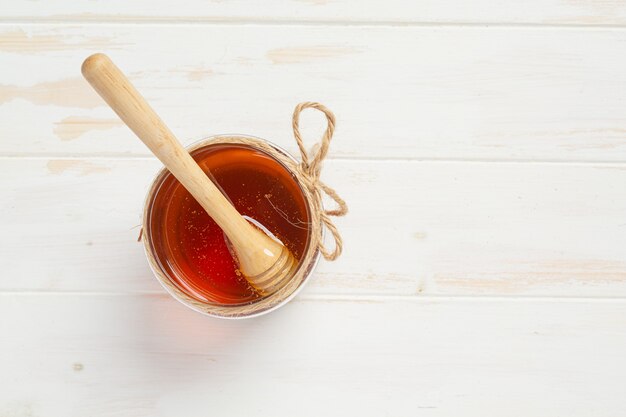 Delicious honey on white wooden surface