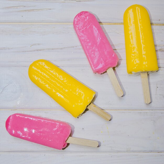 Delicious ice creams on wooden surface