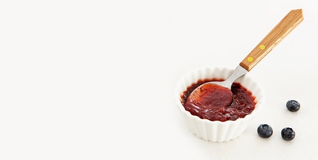 Delicious jam with spoon copy space