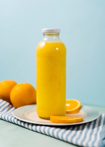Delicious juice bottle and oranges