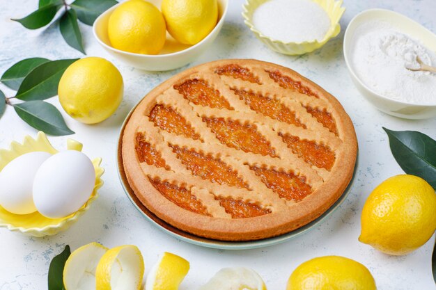 Delicious lemon pie with fresh lemons on light