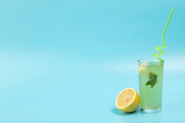 Delicious lemonade on blue backgound with copy space