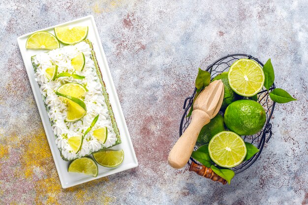 Delicious lime cake with fresh lime slices and limes.