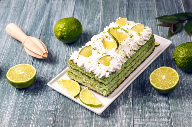 Delicious lime cake with fresh lime slices and limes