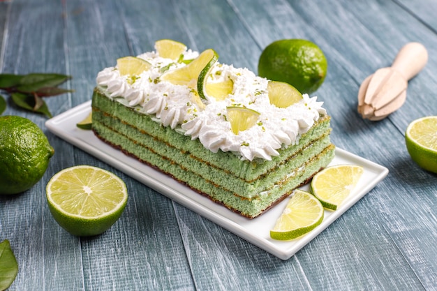 Delicious lime cake with fresh lime slices and limes.
