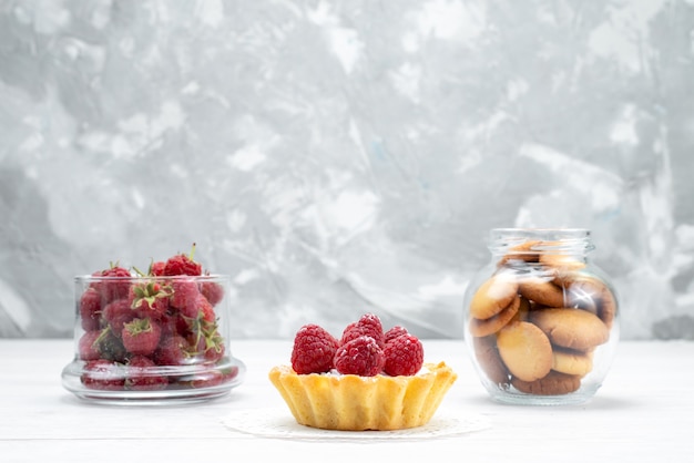 delicious little cake with raspberries along with strawberries and cookies on light, cake biscuit sweet bake berry