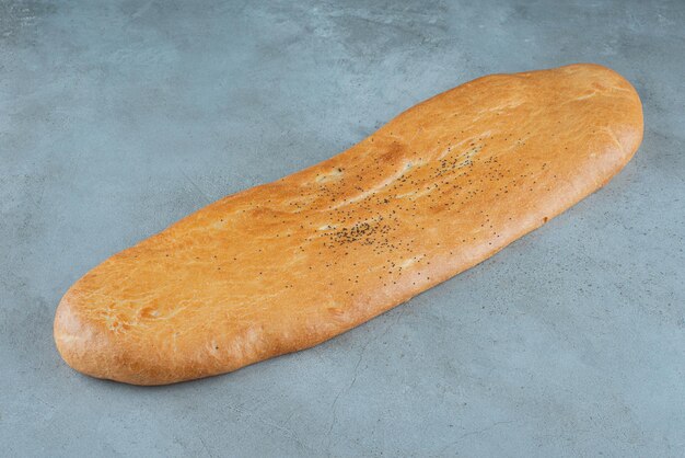 Delicious loaf of bread on marble.