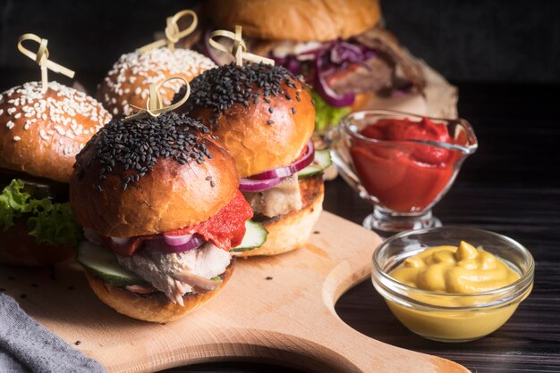 Delicious looking hamburgers on wooden board