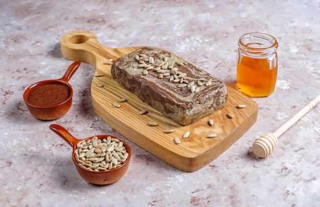 Free photo delicious marble halva with sunflower seeds,cocoa powder and honey,top view