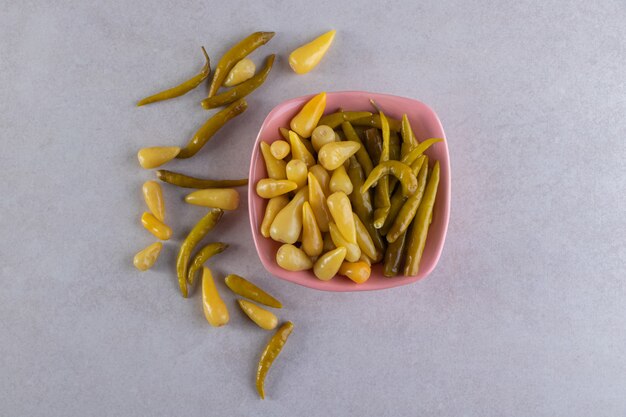 Delicious marinated pickled cucumbers placed on stone table . 