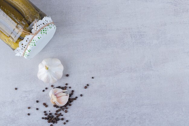 Delicious marinated pickled cucumbers placed on stone table .