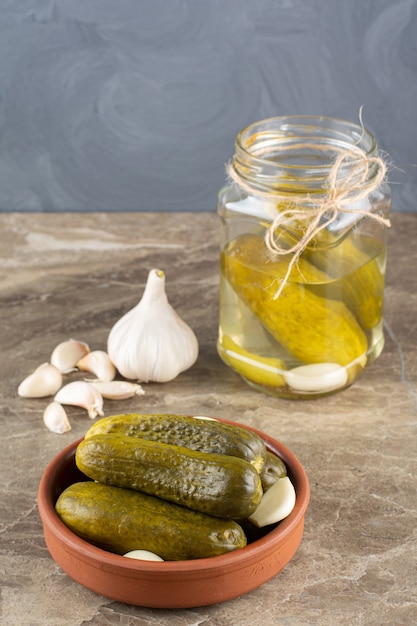 Delicious marinated pickled cucumbers with fresh garlic .