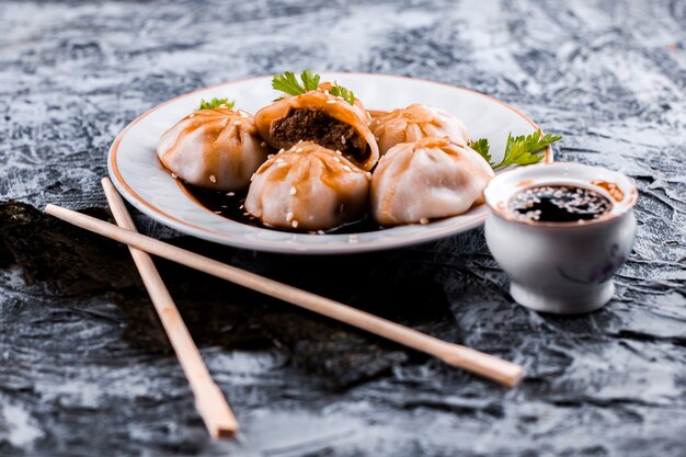 Delicious meat dumplings and sauce front view