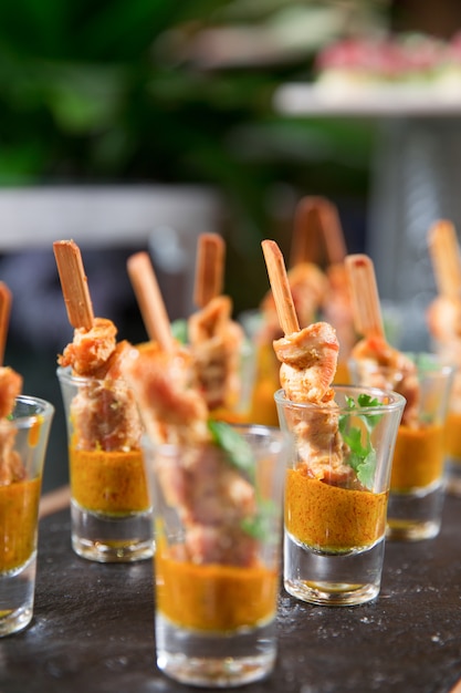 Free photo delicious meat snacks with sauce in shot glasses