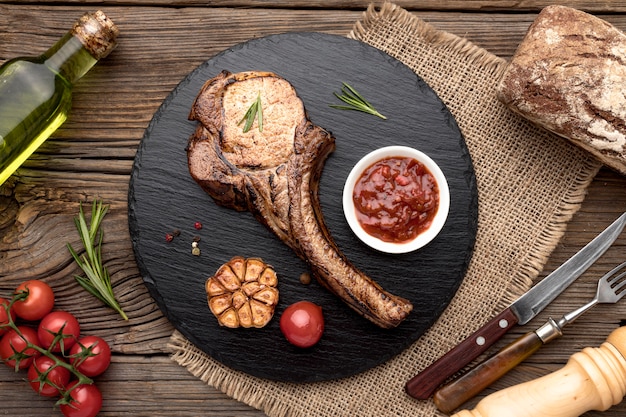 Delicious meat with sauce on wooden board