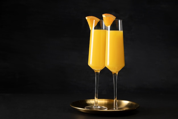 Delicious mimosa cocktail glasses with orange slices