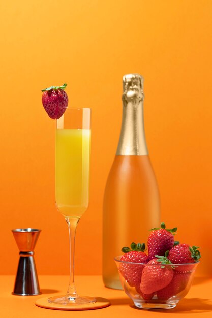 Delicious mimosa cocktail with orange background