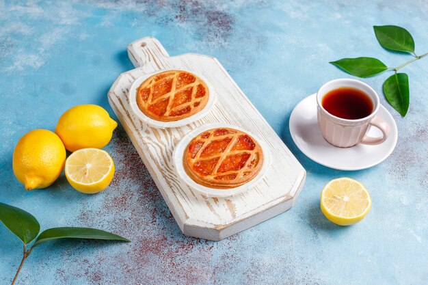 Delicious mini lemon pies with fresh lemons,top view