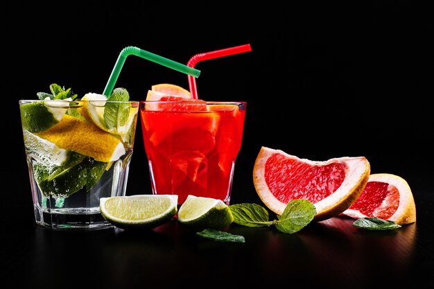 Delicious mojito, rum and cola, blood orange and vodka cocktails served with fruit