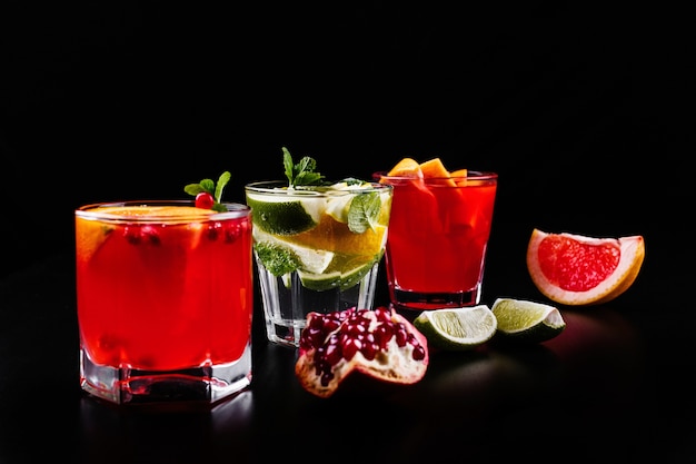 Delicious mojito, rum and cola, blood orange and vodka cocktails served with fruit