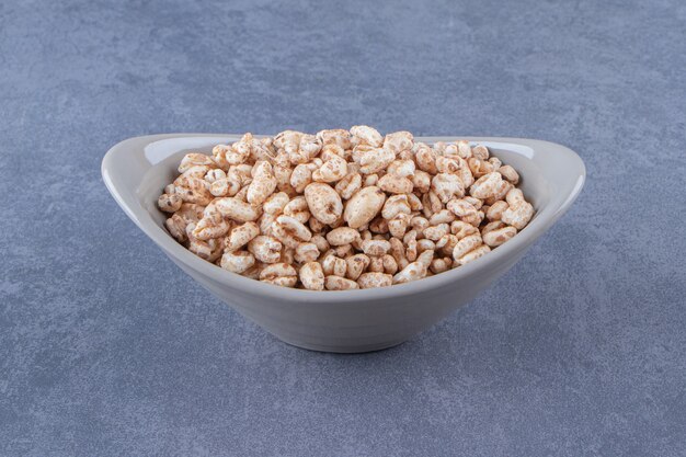 Delicious muesli in a bowl , on the blue background.