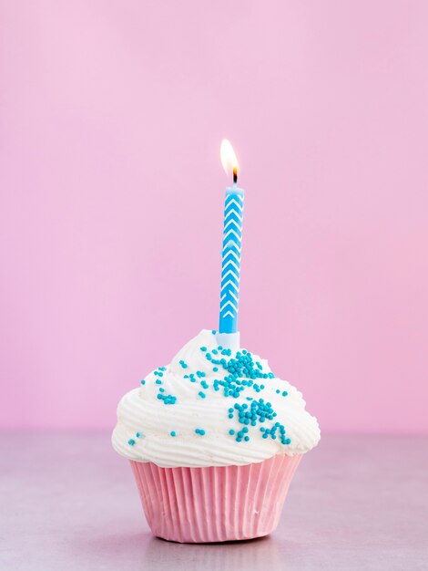 Delicious muffin with blue candle