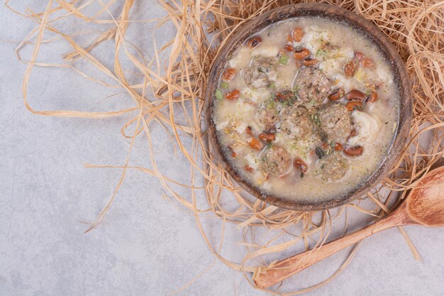 Delicious mushrooms soup in wooden bowl with spoon