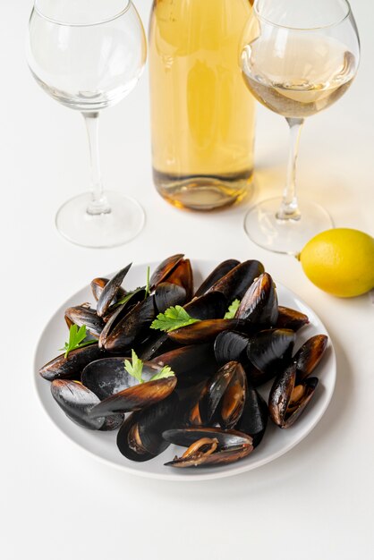 Delicious mussels next to champagne