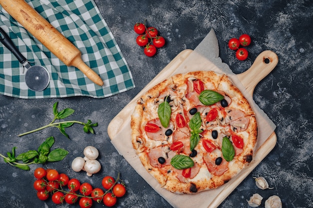Delicious Neapolitan pizza on board with cherry tomatoes