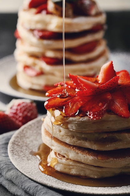 Delicious pancakes with fruit and honey