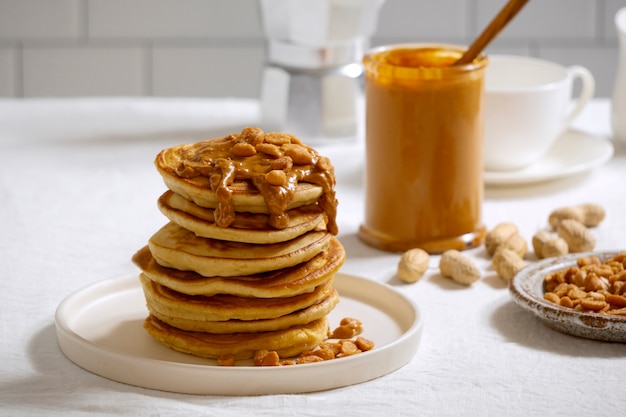 Free photo delicious pancakes with peanut butter arrangement