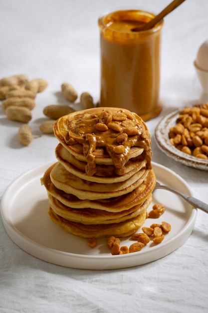 Free photo delicious pancakes with peanut butter arrangement