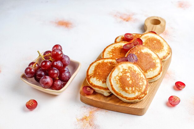 Delicious pancakes with red grapes.