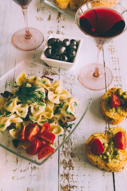 Delicious pasta dish with glass of wine