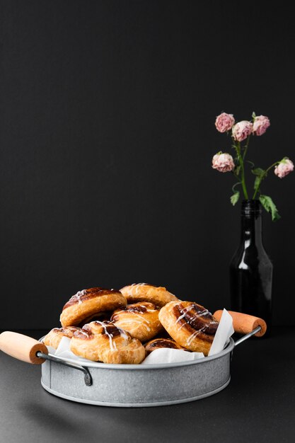 Delicious pastries in a tray with flowers