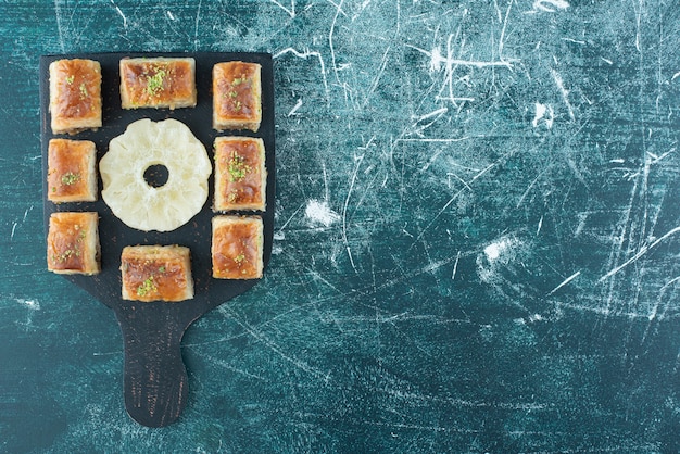 Delicious pastries with dried pineapple on a dark board. high quality photo