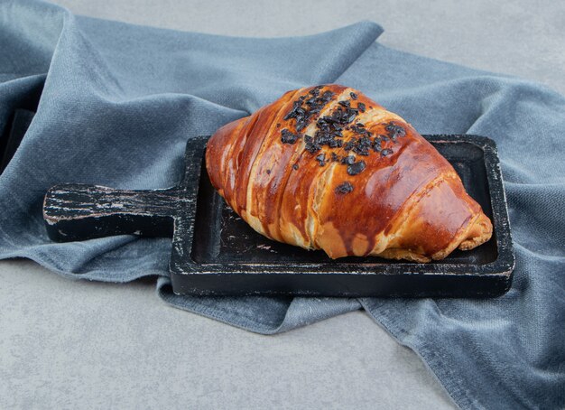 Delicious pastry on black board with cloth. 