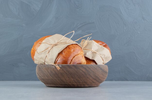 Delicious pastry sausages in wooden bowl.