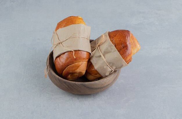 Delicious pastry sausages in wooden bowl.