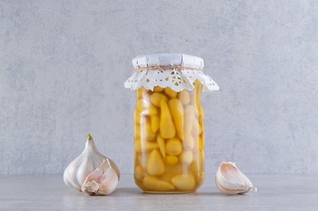 Delicious pickled cucumbers with pepper corns and fresh garlic .