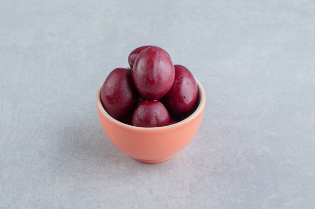 Delicious pickled plum on the marble surface