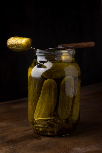 Delicious pickles in transparent jar