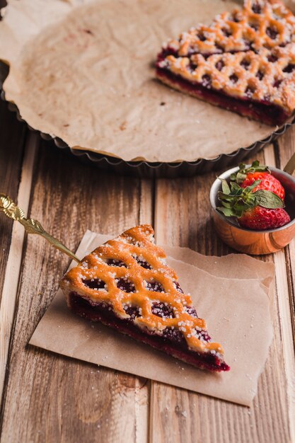 Delicious pie and small ladle with strawberries