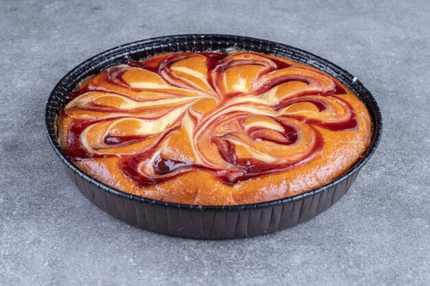 Delicious pie with berry on marble surface