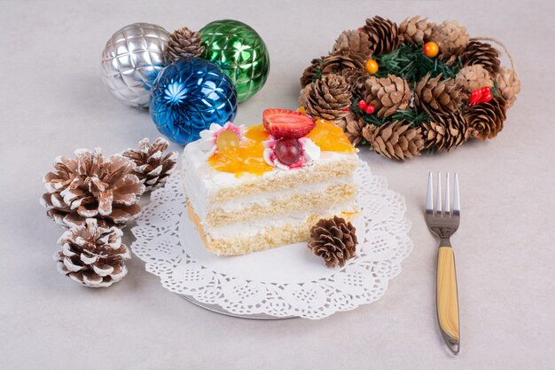 A delicious piece of cake with pinecones on white background. High quality photo