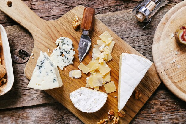 Delicious pieces of cheese wooden board