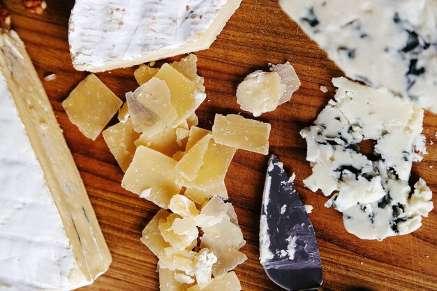 Delicious pieces of cheese wooden board